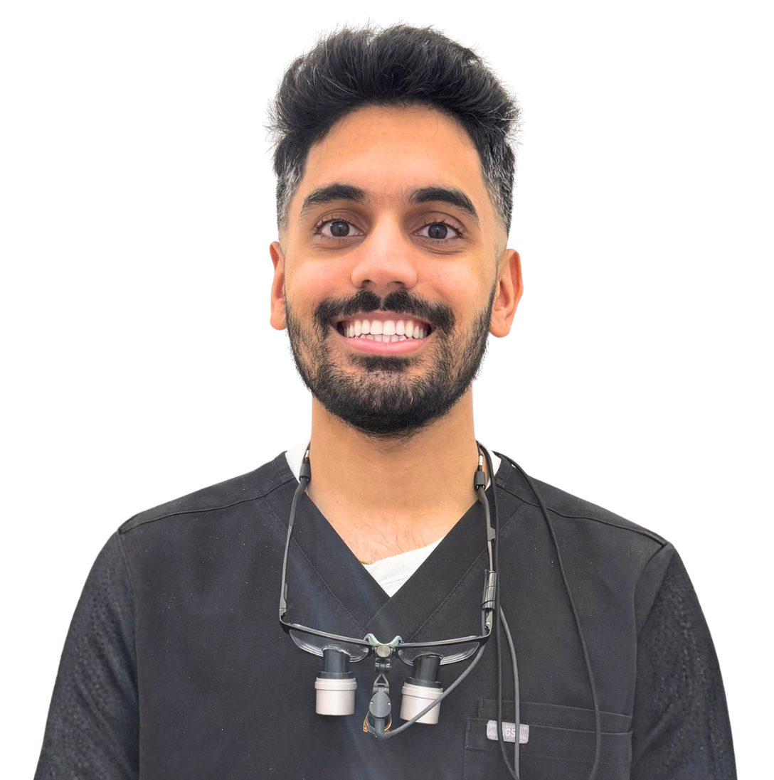 Dr. Nikul Parekh, smiling with his dental loupes around his neck.